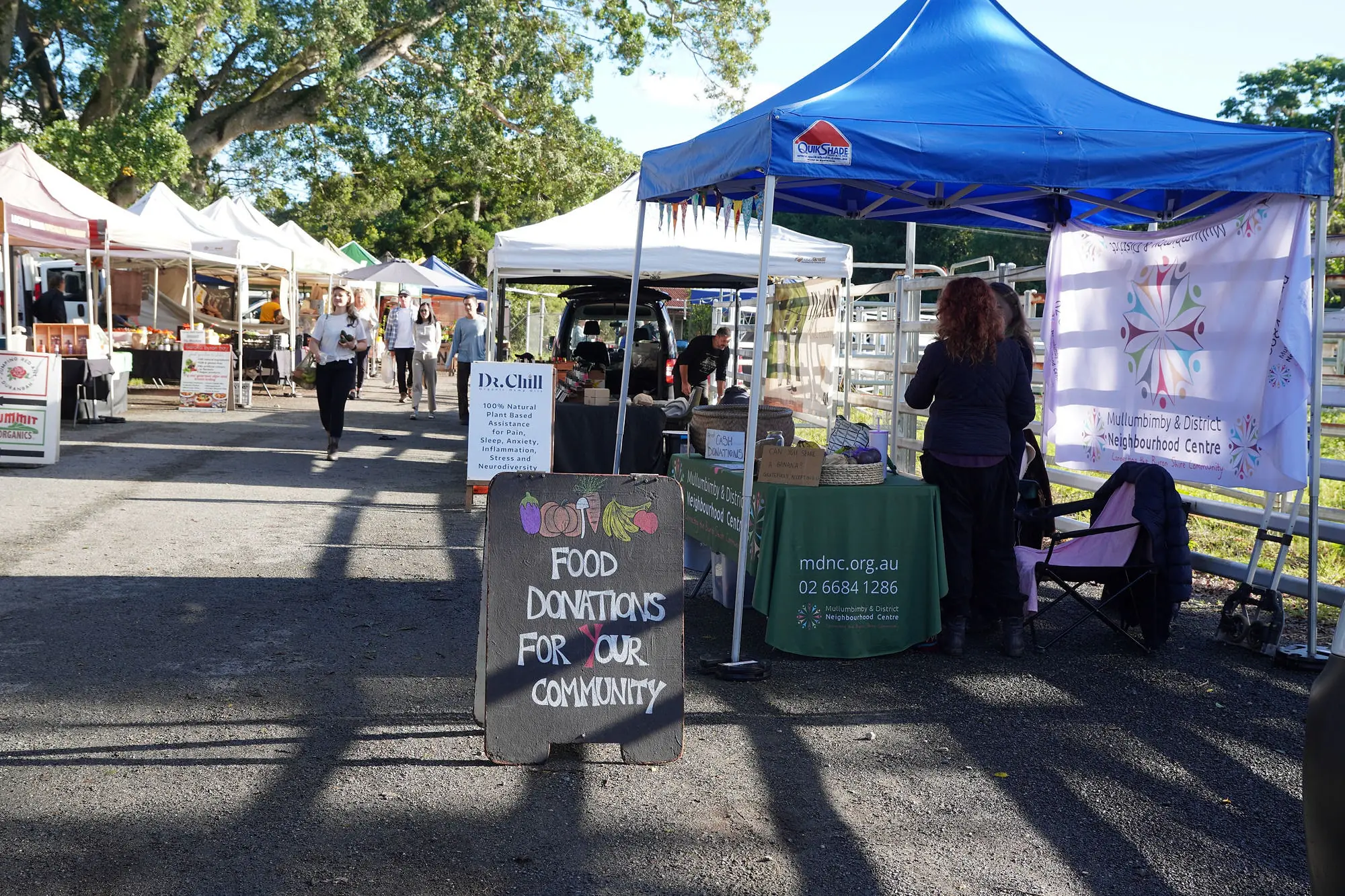 A 'Food donations for your community' sign at the Mullumbimby and District Neighbourhood Centre stall at the Mullum Farmers Market