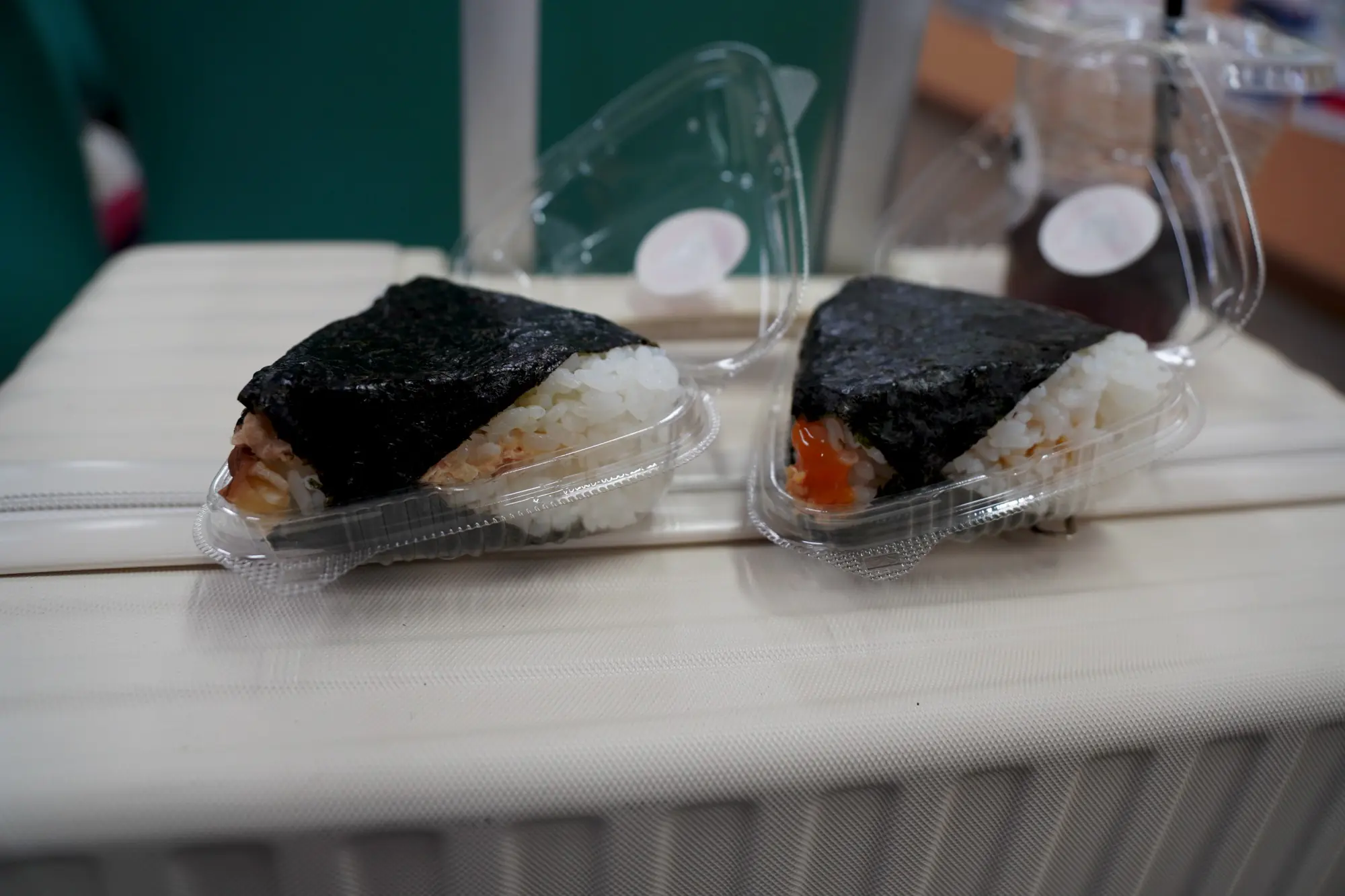 Two triangular onigiri side-by-side, showing the simple hand-pressed shape
